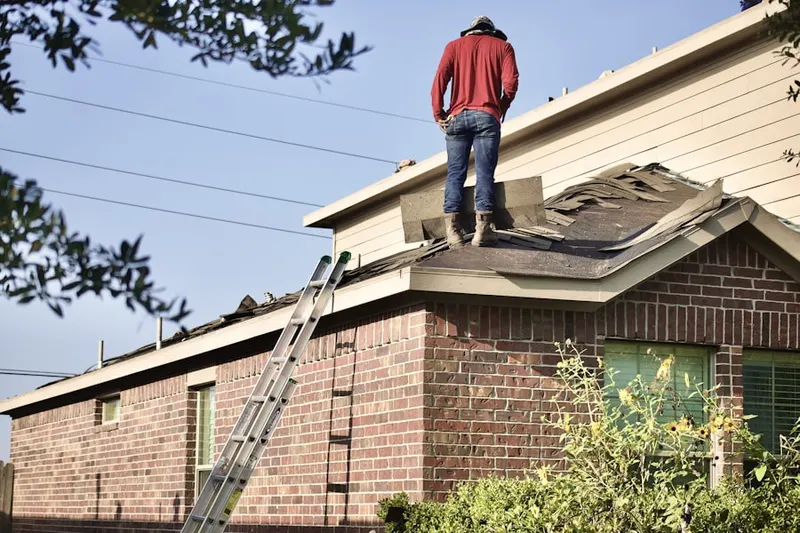 Professional roofer working on a residential roof in Conovertown